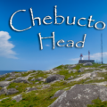 The white octagonal Chebucto Head Lighthouse standing on a high rocky cliff overlooking the Atlantic Ocean and the entrance to Halifax Harbour in Nova Scotia.