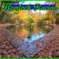 The heart-shaped Julie’s Pond at Hemlock Ravine Park in Halifax, surrounded by colorful autumn leaves and old-growth hemlock trees and a duck in the foreground.