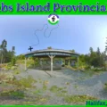 This SEO-optimized alt description for McNabs Island Provincial Park balances descriptive imagery with the specific keywords users often use when searching for outdoor activities in the Halifax area. Alt Description Panoramic view of the welcome shelter at McNabs Island Provincial Park in Halifax, Nova Scotia, featuring informative trail maps and benches, surrounded by coastal trees, rocky shoreline, and the ocean under a clear blue sky