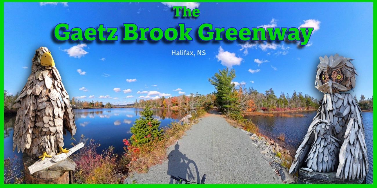 A promotional graphic for "The Gaetz Brook Greenway, Halifax, NS" featuring a scenic gravel trail bordered by water and autumn trees under a bright blue sky, with the shadow of a cyclist in the foreground. The trail photo is framed by two large wooden sculptures: an eagle on the left and an owl on the right